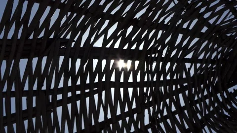 Sunbeams on the straw umbrella on the beach Stock Footage 246594365