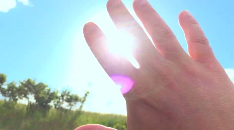 Sunbeams through Hand shining rays Stock Footage 50247835