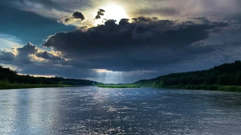 Sunbeams through thunderclouds over the river Stock Footage 272263369