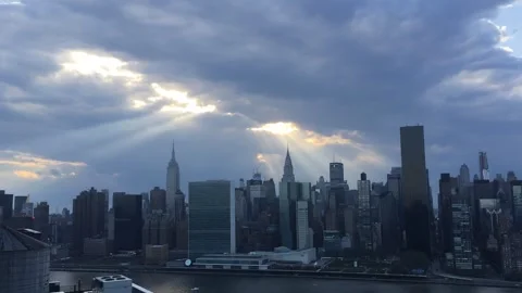 Sunbeams turn to sinister looking clouds threatening the NYC Skyline Stock Footage 327169558