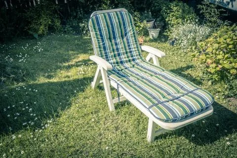 Sunbed in the garden during summer. Stock Photos