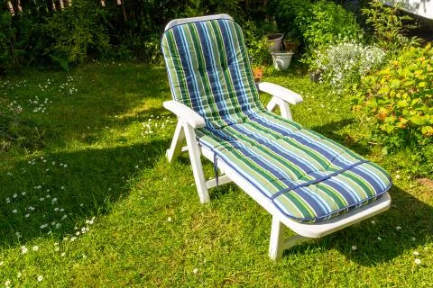 Sunbed in the garden during summer. Stock Photos