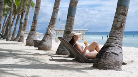 Sunbed lounging with a refreshing fruit drink Stock Footage 305630257