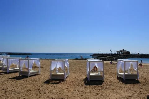 Sunbeds and bar on the beach Stock Photos