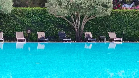 Sunbeds and Umbrellas Around the Pool at the Hotel. Hotel with Swimming Pool. Stock Footage 246382487