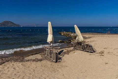 **Sunbeds on an empty beach at the end of the tourist season in Turgutreis,.. Stock Photos