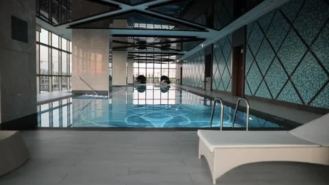Sunbeds in the Indoor swimming pool Stock Footage 172200833