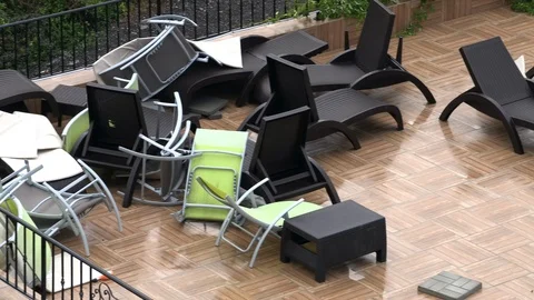 Sunbeds at the pool piled up broken and bent after huge storm Stock Footage 106298661
