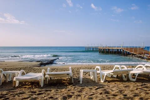 Sunbeds in a row on empty beach in Turkey Stock Photos