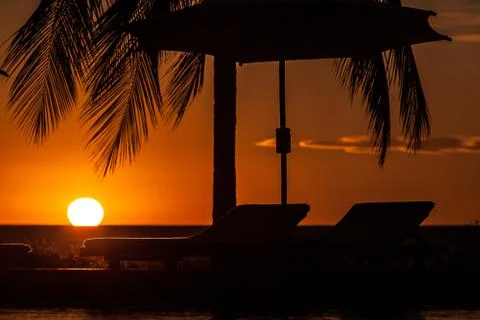 Sunbeds at sunset Stock Photos