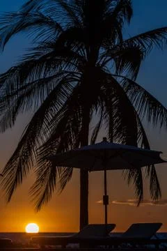 Sunbeds at sunset Stock Photos