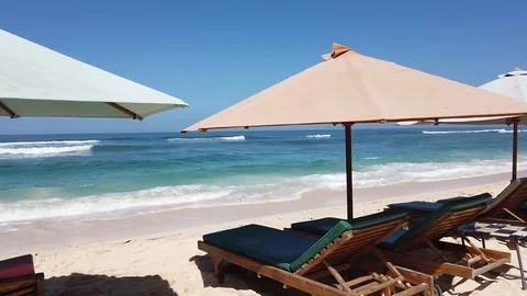 Sunbeds with umbrellas on the beach. Stock Footage 108577856