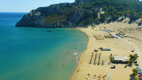 Sunbeds with umbrellas on the sandy shore of one of the best beaches of the Stock-Footage 118949532