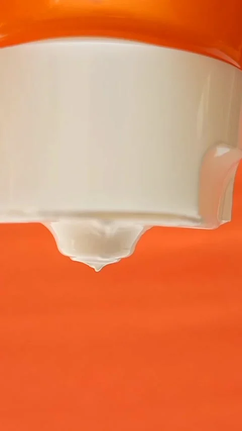 Sunblock Cream Texture Squeezed From Tube on Orange Background, Skincare Protect Stock Footage 327900084