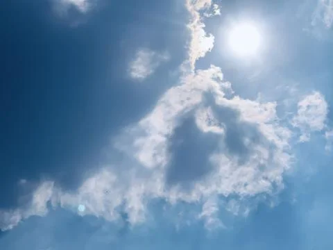 Sunburst and Clouds in Blue Sky Over Jakarta Indonesia Stock Photos