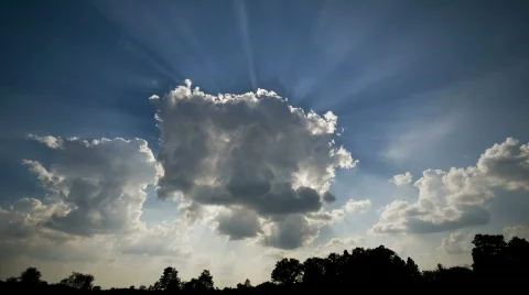 Sunburst from cloud timelapsed over rural scene Stock Footage 728424