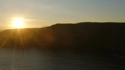 Sunburst Over Silhouetted Cliffs of Moher, Slow Aerial Pan Stock Footage 291407448