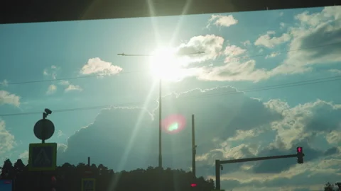 Sunburst over urban intersection with silhouetted utility poles and power lines Video stock 348263884