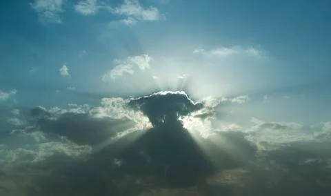 Sunburst through the clouds. 库存照片