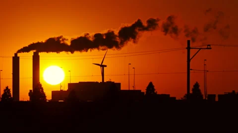 Sundown in 4k between a power supply. Funnels are smoking. Stock Footage 66519970