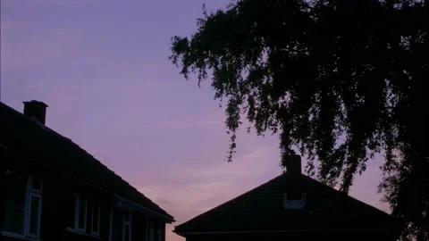 Sundown timelapse between a house and tree Stock Footage 131323797
