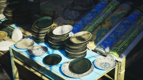 Sundrenched souk stall featuring ceramic ware and vibrant patterns Video stock 338339775