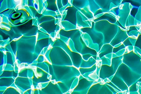 Sunflecks on emerald water surface in a swiming pool Stock Photos
