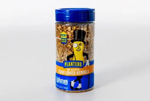 Sunflower kernels in container displayed on simple background with friendly Stock Photos