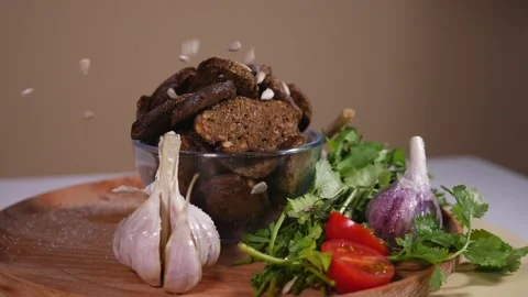 Sunflower seeds falling on a plate with bread crackers and vegetables 1 Video stock 124380288