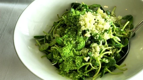 Sunflower sprouts salad in white dish on the table. 4K Vídeo Stock 104780902
