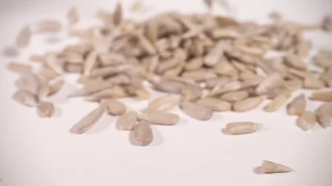 Sunfower seeds piling up in slow motion Stock Footage 77392020