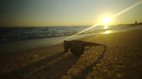 Sunglass on the beach sand Video stock 212987963