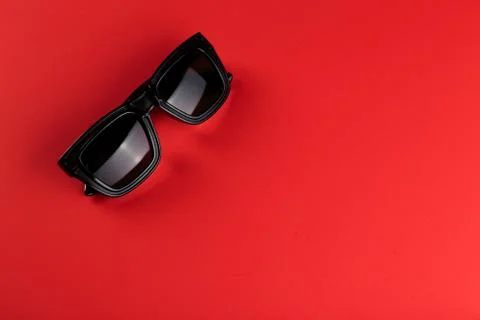 Sunglass on the red background with copy space. Stock Photos