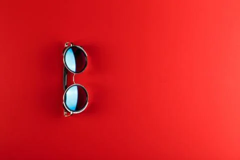 Sunglass on the red background with copy space. Stock Photos
