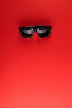 Sunglass on the red background with copy space. Stock Photos