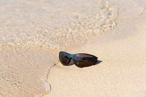 Sunglass in the sand Foto stock