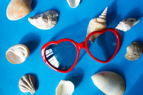 Sunglasses and seashells Stock Photos