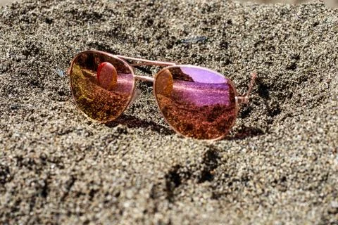 Sunglasses at the beach with beach ball reflection. Stock Photos