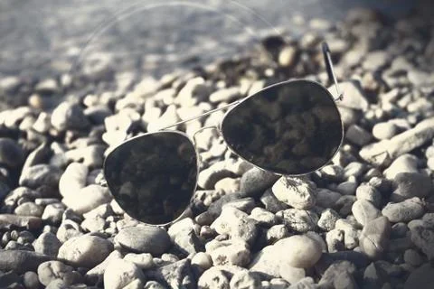 Sunglasses on the beach Stock Photos