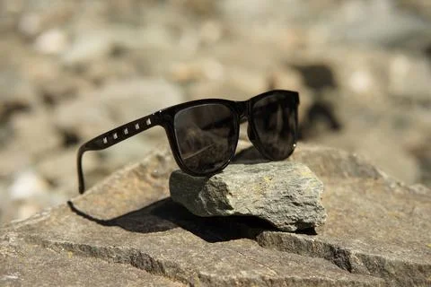 Sunglasses black with silver rectangled rivets on glasses temples an rocks .. Stock Photos