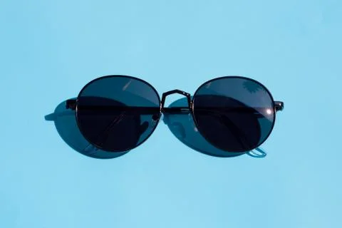 Sunglasses on blue background. Enjoy holiday concept. Stock Photos