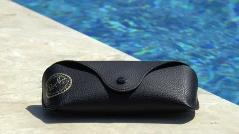 Sunglasses Case Next To Swimming Pool Stock Footage 96126473