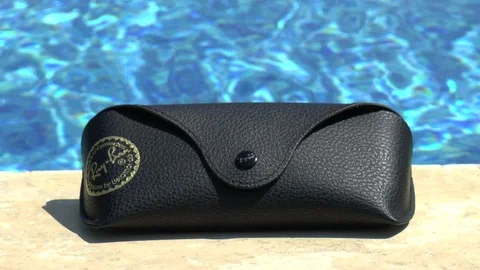 Sunglasses Case Next To A Swimming Pool Stock Footage 111645328