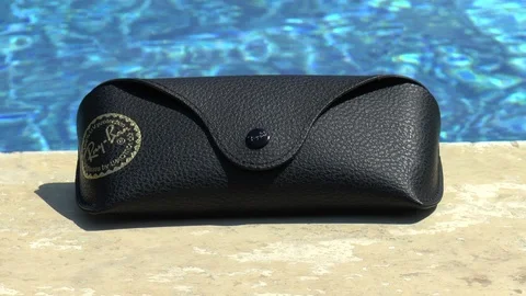 Sunglasses Case Next To Swimming Pool Stock Footage 111645598
