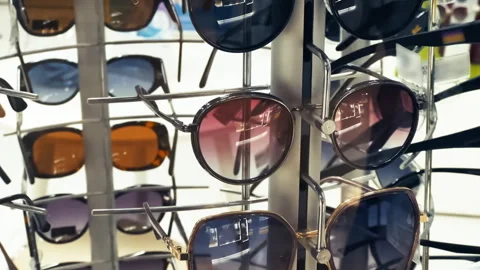 Sunglasses Display Stand in Optical Store with Various Styles and Colors Stock Footage 327175606