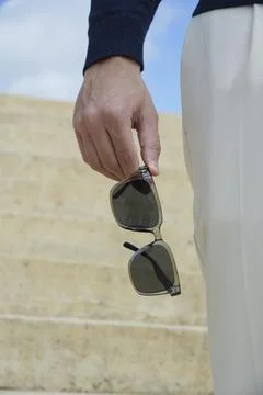 Sunglasses Held in Mans Hand Stock Photos