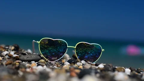 Sunglasses Lying On The Sand. In A Sunglasses Reflected Sea, Waves And Sky. Stock-Footage 100505650