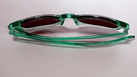 Sunglasses moving in circular motion on white Stock Footage 111887496