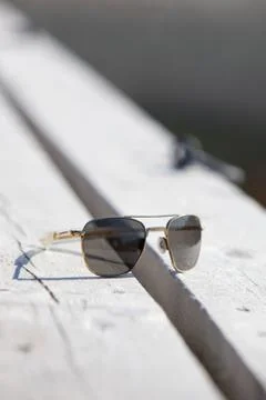 Sunglasses on a pier.gn Stock Photos