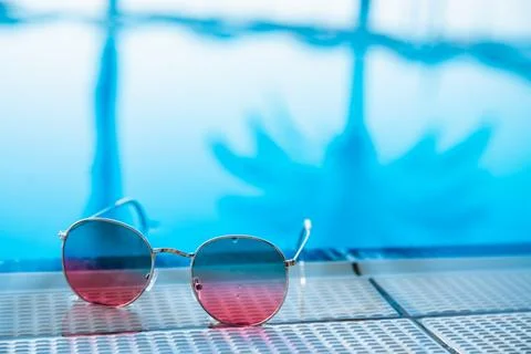 Sunglasses on pool background, reflection of palm trees, travel concept, re.. Stock Photos